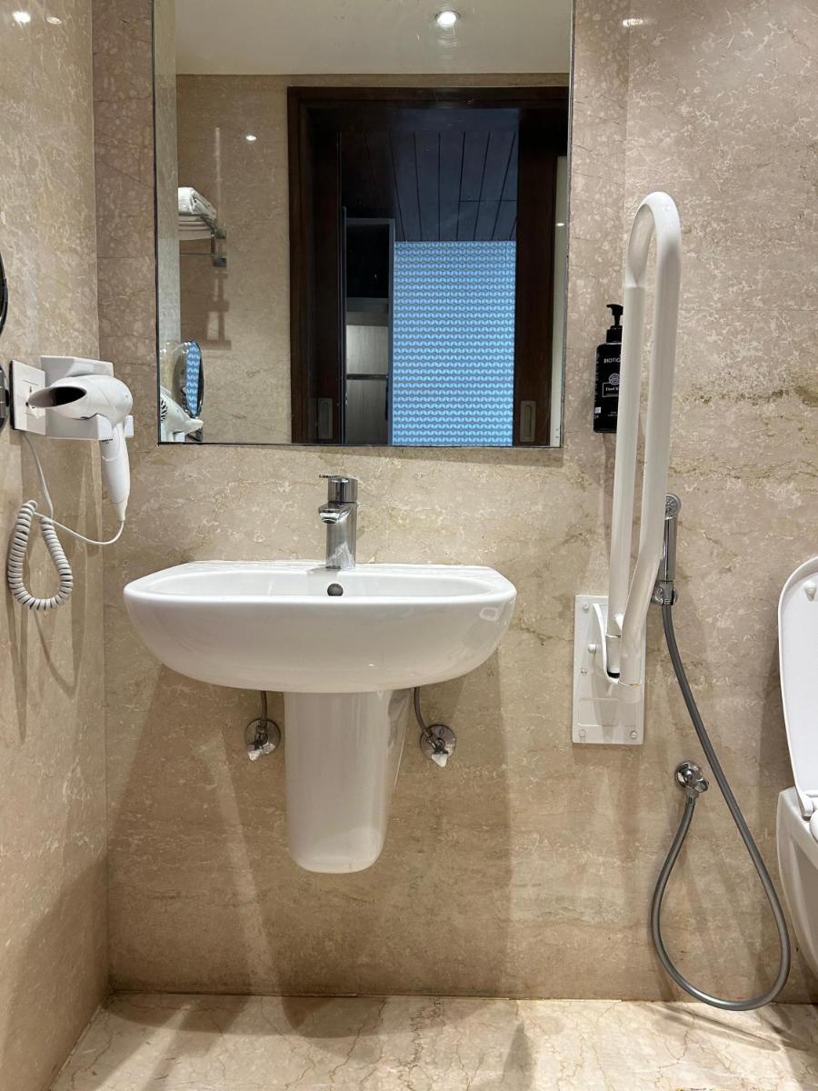 a bathroom with a sink and a mirror at Ramada Plaza by Wyndham Lucknow in Lucknow