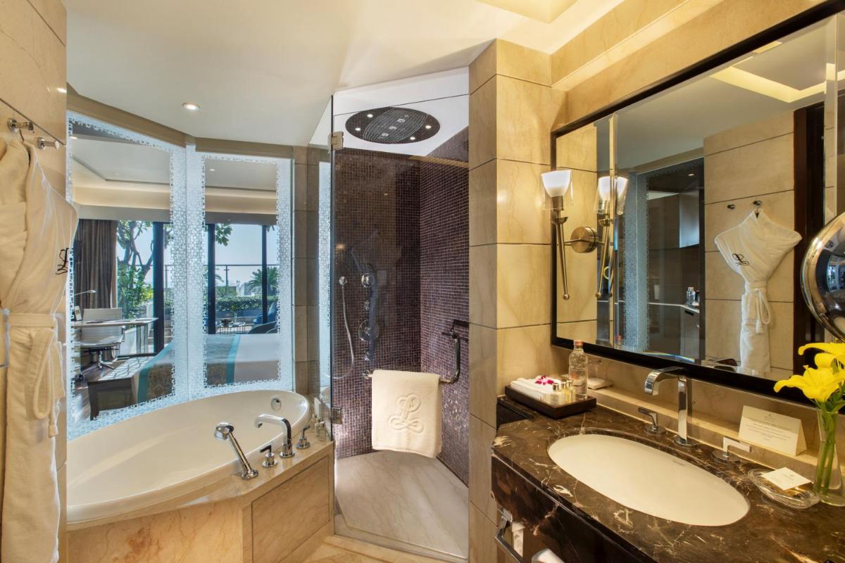 a bathroom with a tub and a sink at The Leela Ambience Convention Hotel Delhi in New Delhi