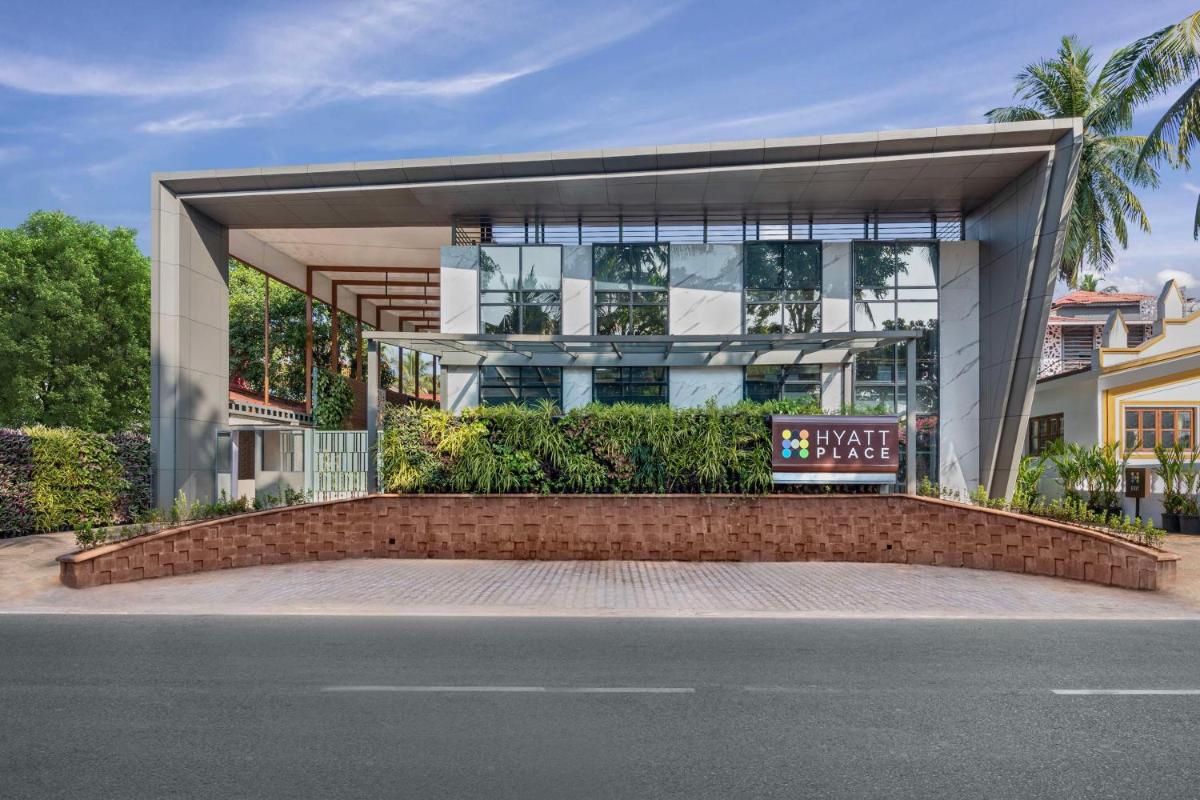 a building with a sign in front of a street at Hyatt Place Goa Candolim in Candolim a building with a sign in front of a street at Hyatt Place Goa Candolim in Candolim