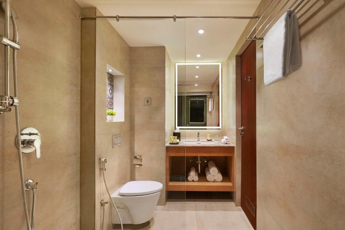a bathroom with a toilet and a sink at Hyatt Place Goa Candolim in Candolim a bathroom with a toilet and a sink at Hyatt Place Goa Candolim in Candolim