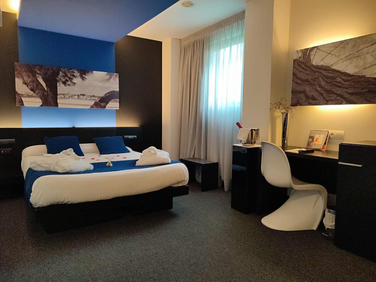 Cama o camas de una habitación en Hotel Playa Ribera