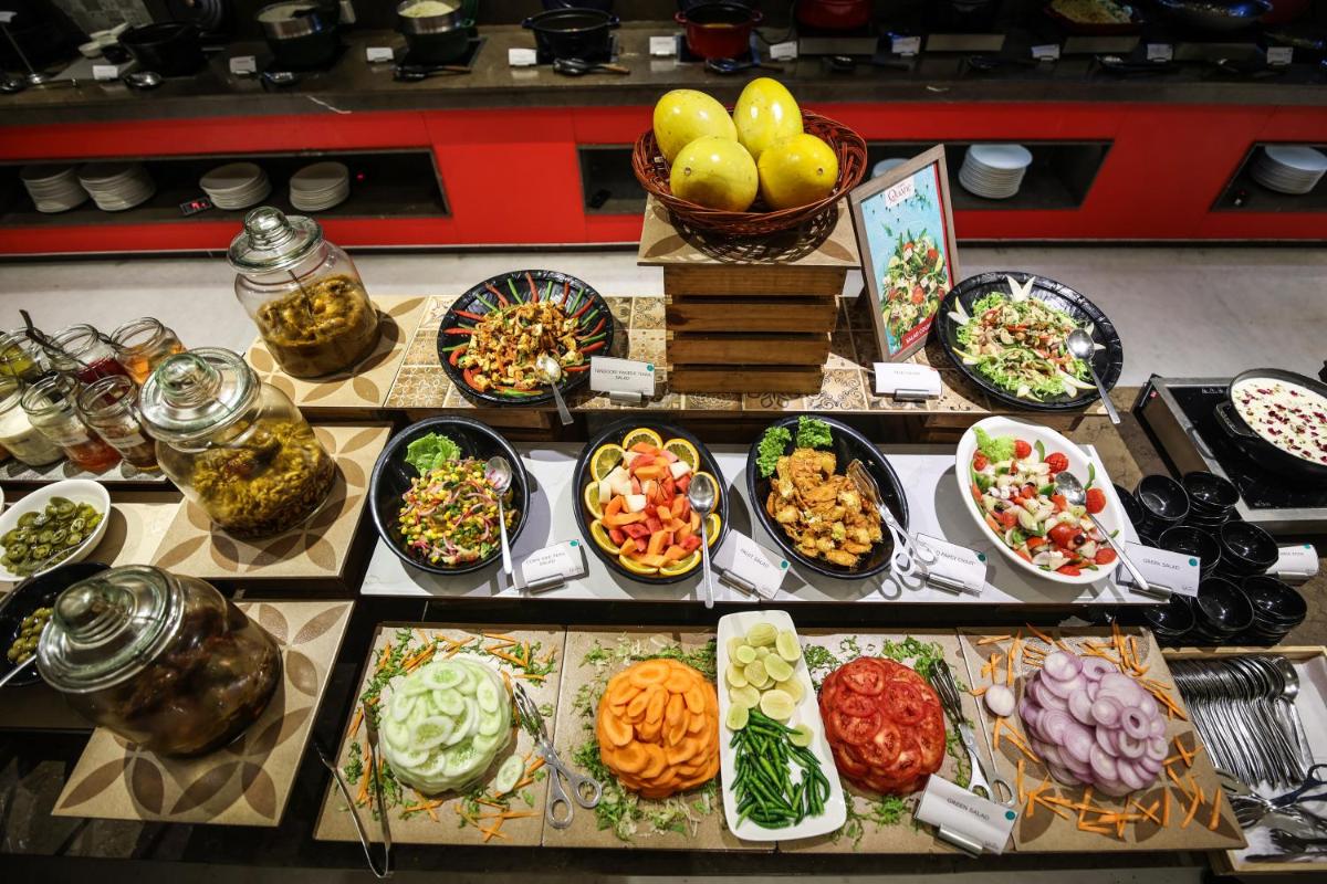 a buffet with many different types of food on a table at Ramada Plaza by Wyndham Lucknow in Lucknow