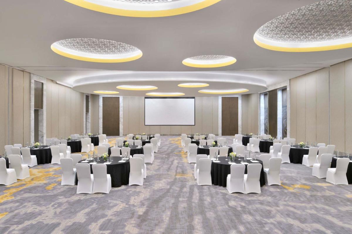 a conference room with tables and chairs and a screen at The Westin Resort & Spa Himalayas in Rishīkesh