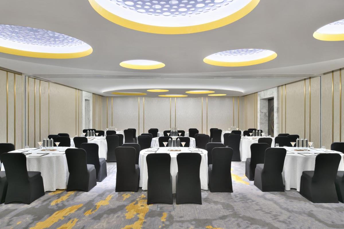 a conference room with white tables and black chairs at The Westin Resort & Spa Himalayas in Rishīkesh