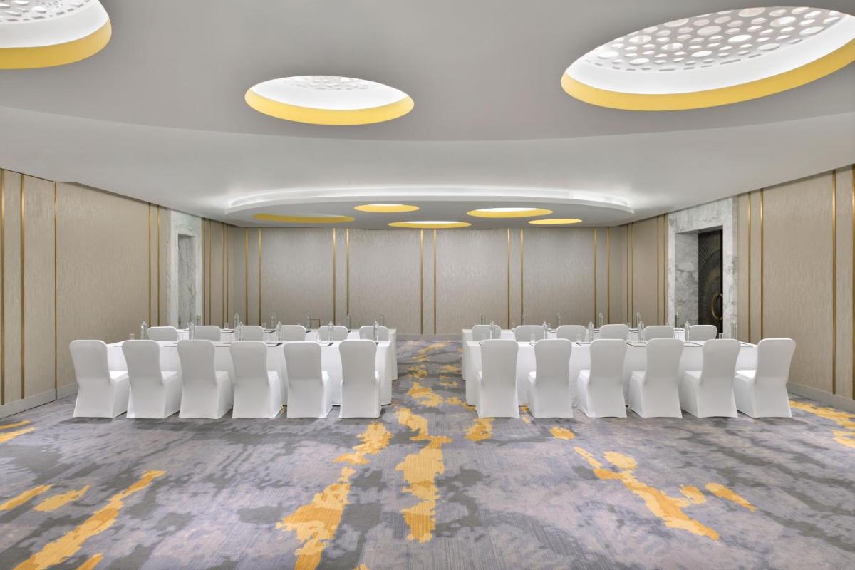 a conference room with white chairs and yellow lines on the floor at The Westin Resort & Spa Himalayas in Rishīkesh