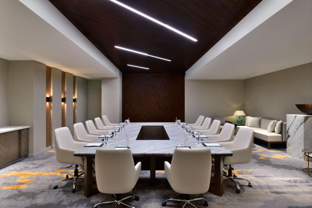 a conference room with a long table and white chairs at The Westin Resort & Spa Himalayas in Rishīkesh