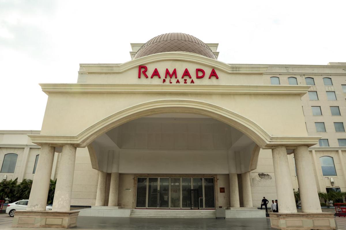 a building with a sign on top of it at Ramada Plaza by Wyndham Lucknow in Lucknow