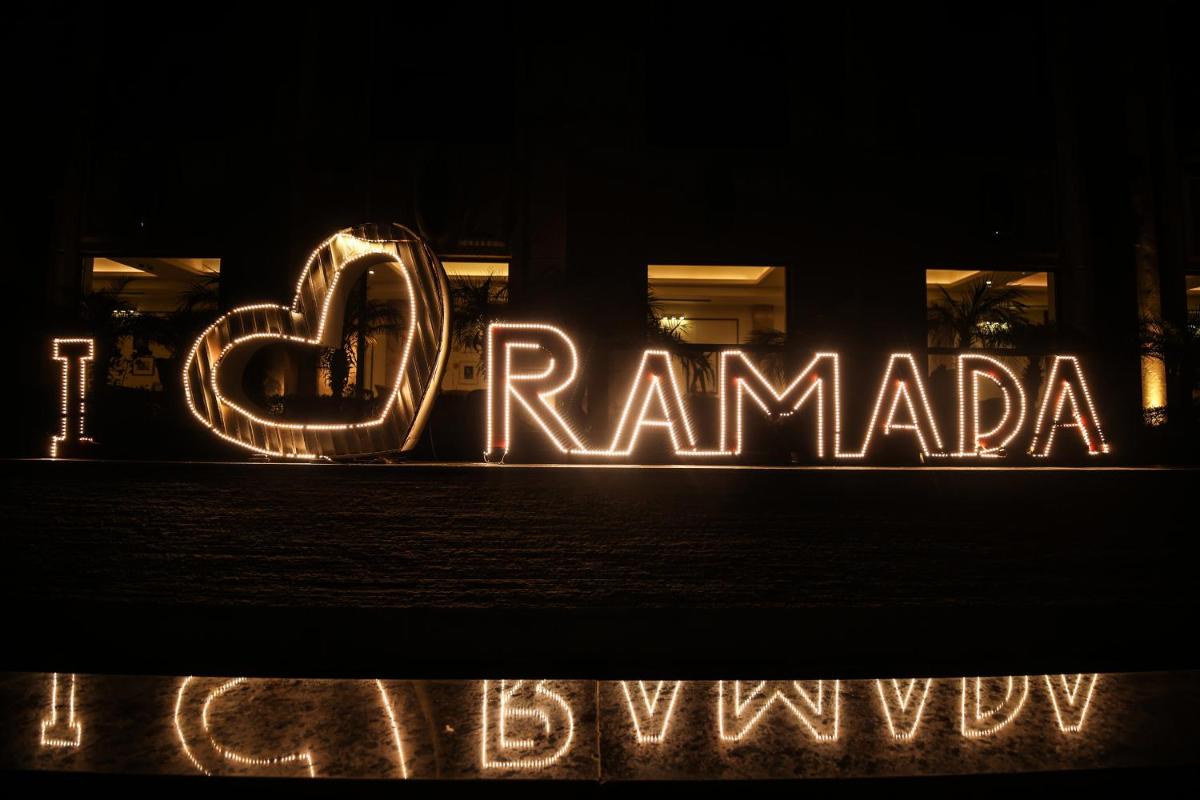 a neon sign that says rammania in front of a store at Ramada Plaza by Wyndham Lucknow in Lucknow
