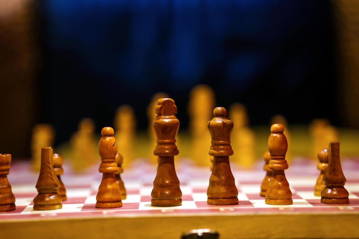 a close up of chess pieces on a chessboard at Ramada Plaza by Wyndham Lucknow in Lucknow