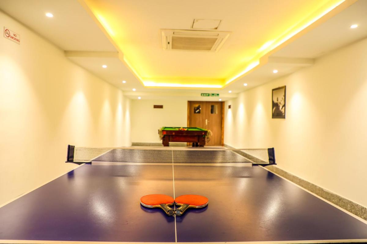 a bowling alley with a ping pong ball on a table at Ramada Plaza by Wyndham Lucknow in Lucknow