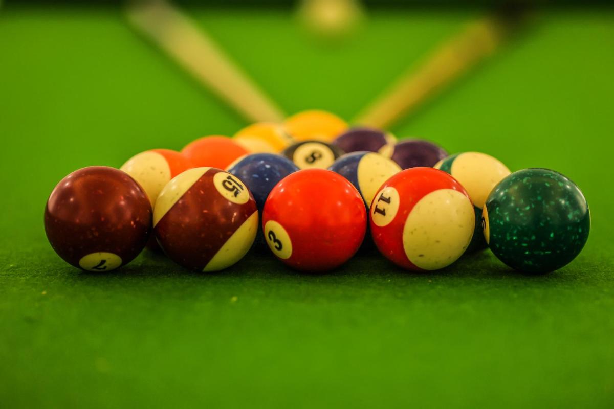 a group of billiard balls on a green table at Ramada Plaza by Wyndham Lucknow in Lucknow