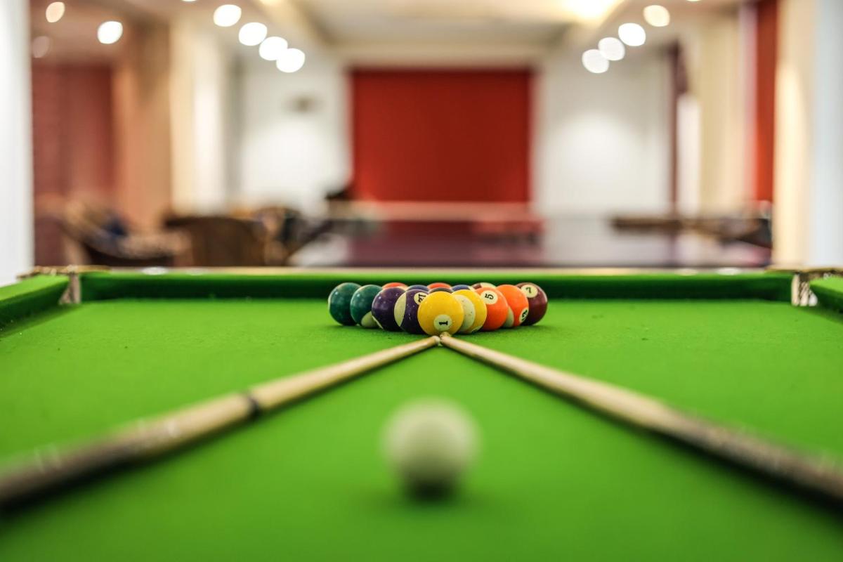 a group of cue balls on a pool table at Ramada Plaza by Wyndham Lucknow in Lucknow