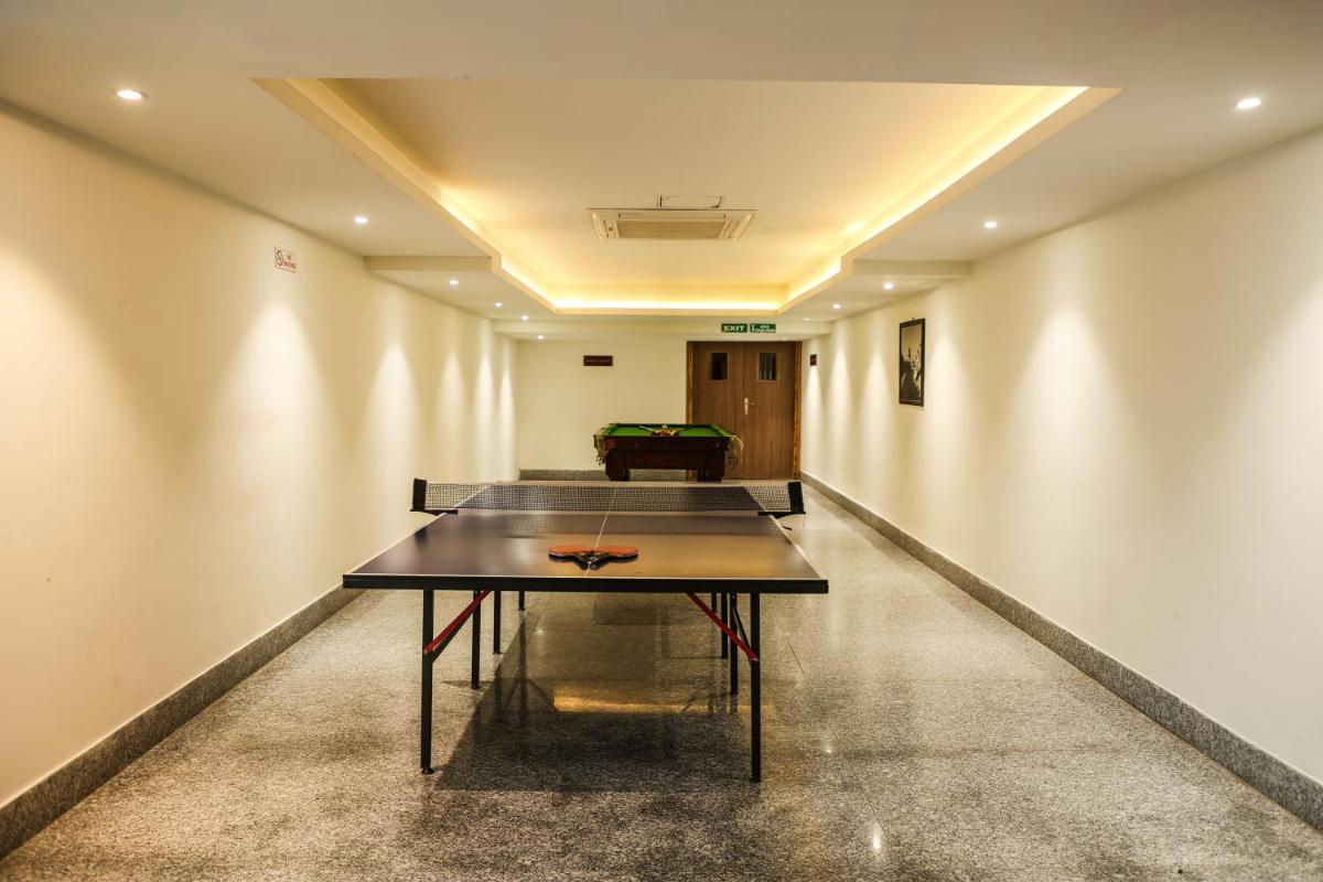 a ping pong table in the middle of a room at Ramada Plaza by Wyndham Lucknow in Lucknow