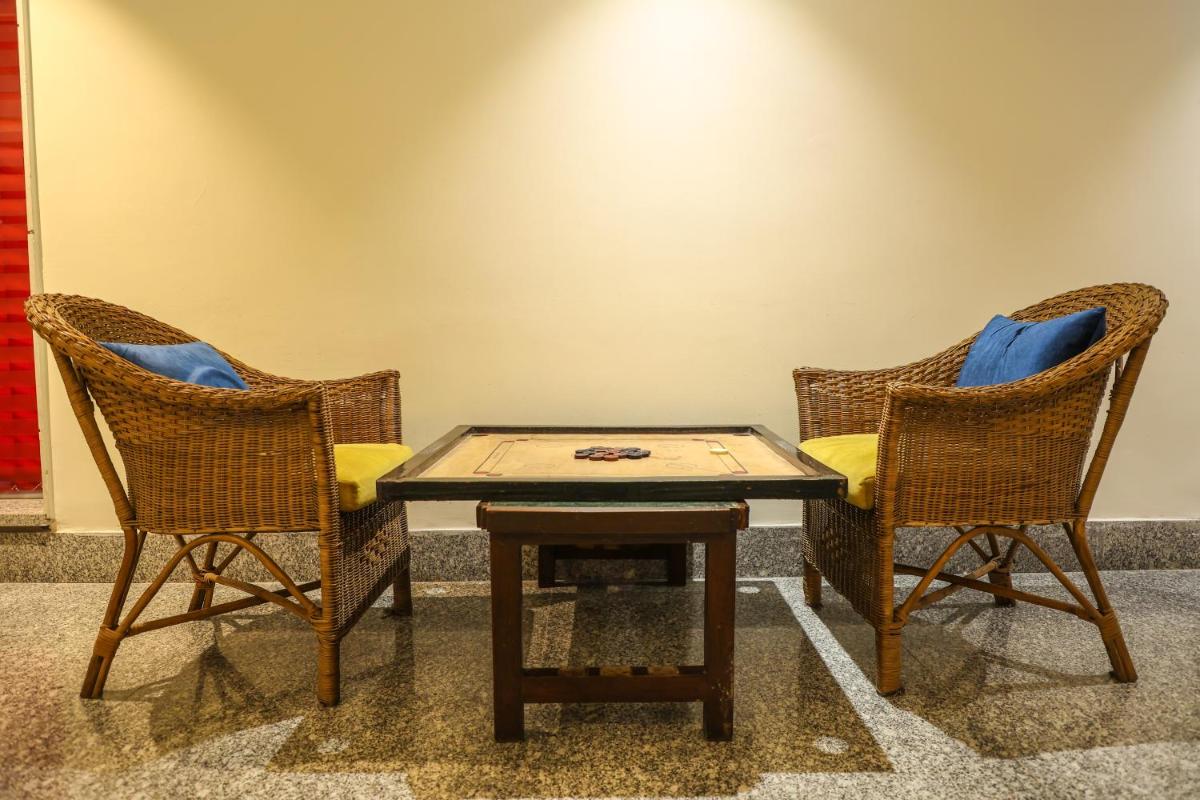 two wicker chairs and a table in a room at Ramada Plaza by Wyndham Lucknow in Lucknow
