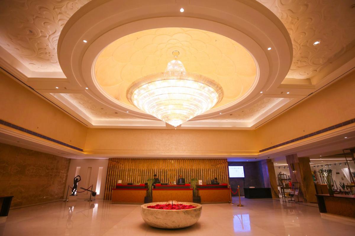 a large lobby with a large ceiling with a large bowl at Ramada Plaza by Wyndham Lucknow in Lucknow