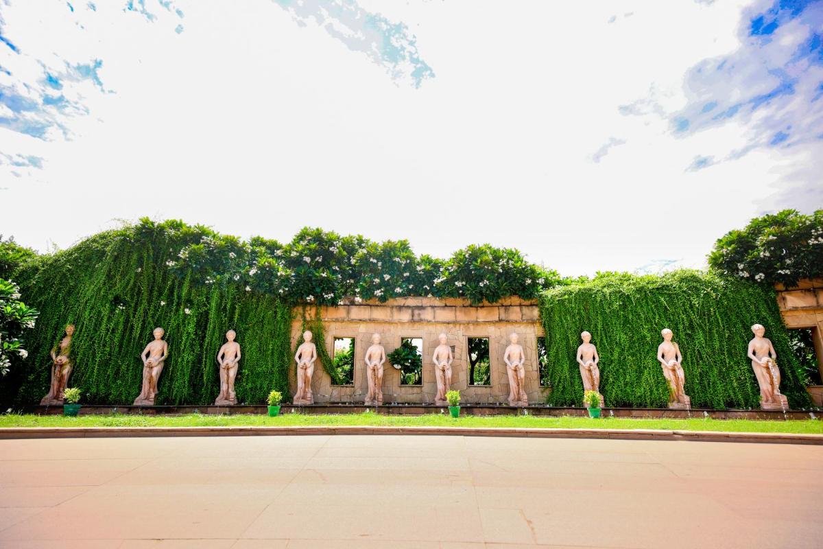 a building with a bunch of statues of men at Ramada Plaza by Wyndham Lucknow in Lucknow