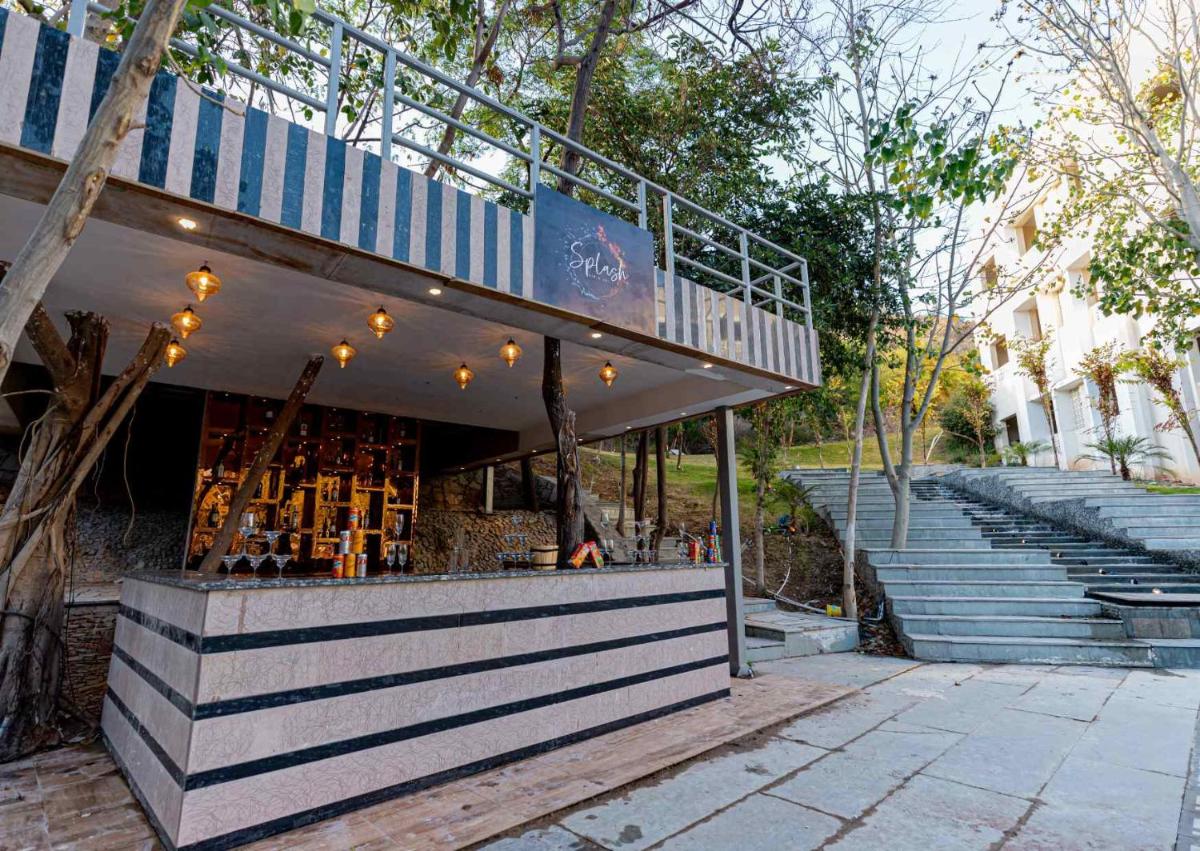 a building with stairs in front of a building at Essentia Luxury Resort & Spa Udaipur in Udaipur