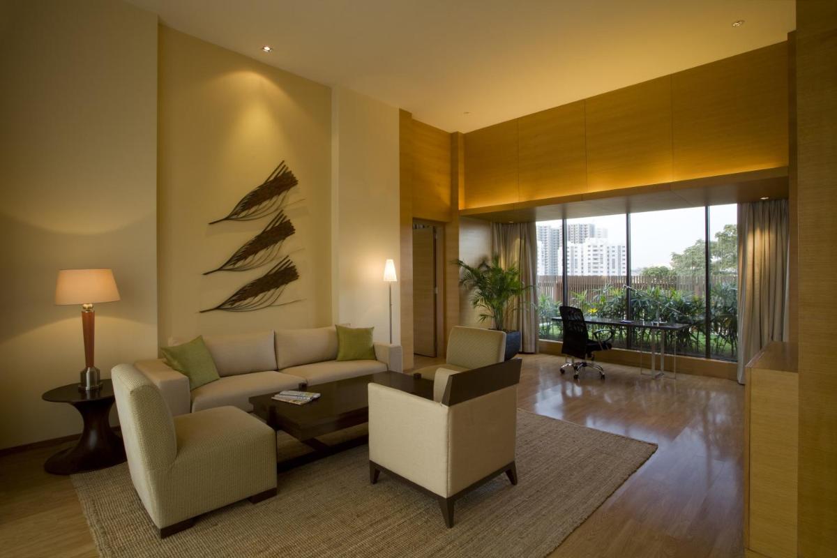 a living room with a couch and a chair at Hyatt Hyderabad Gachibowli in Hyderabad