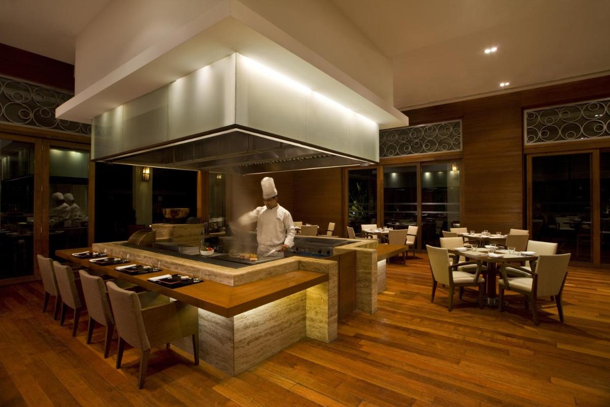 a chef is preparing food in a restaurant at Hyatt Hyderabad Gachibowli in Hyderabad