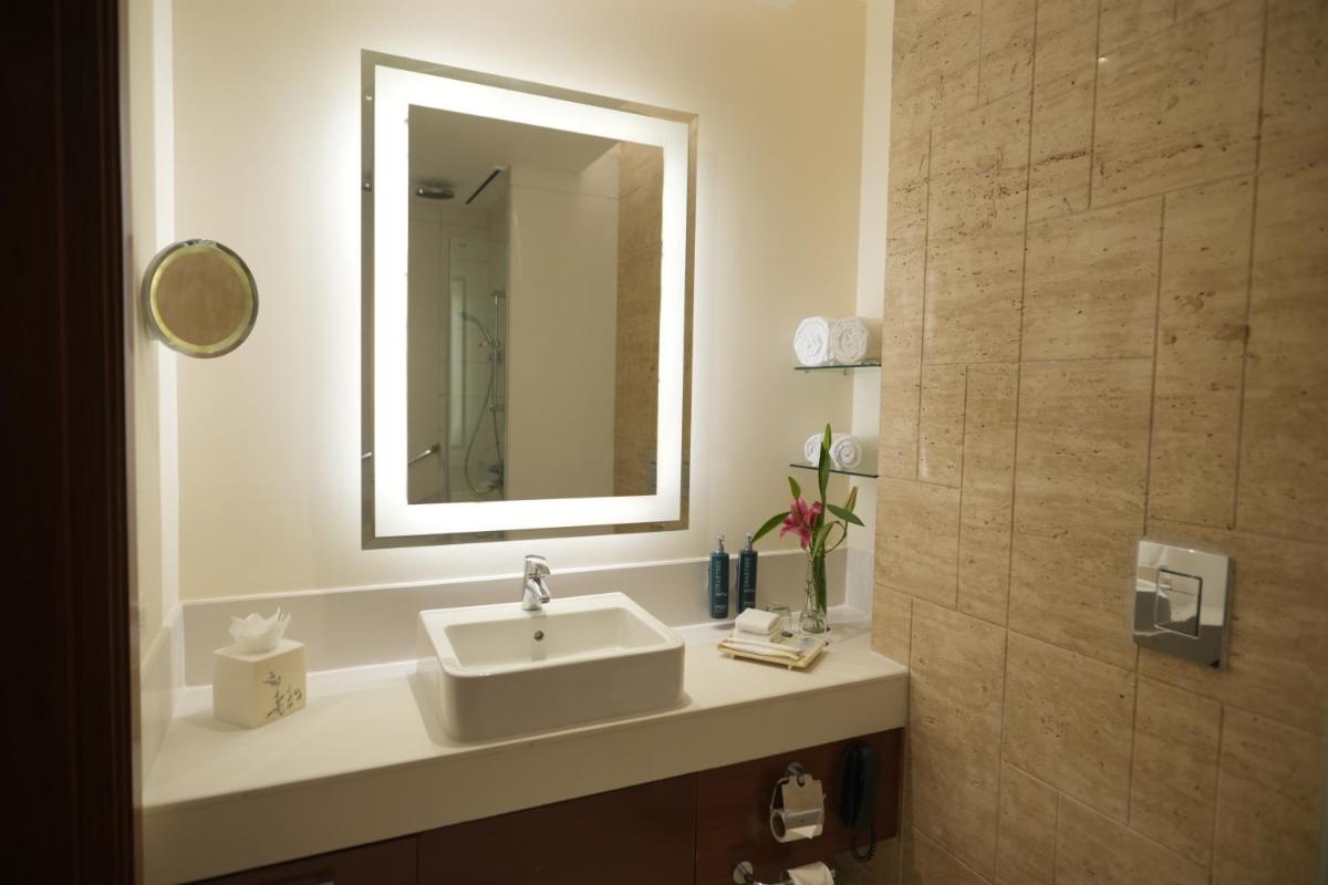 a bathroom with a sink and a mirror at DoubleTree by Hilton Gurgaon New Delhi NCR in Gurgaon