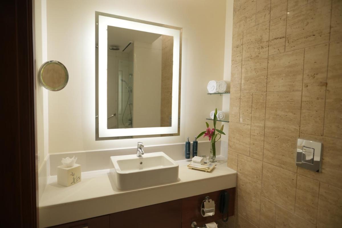 a bathroom with a sink and a mirror at DoubleTree by Hilton Gurgaon New Delhi NCR in Gurgaon