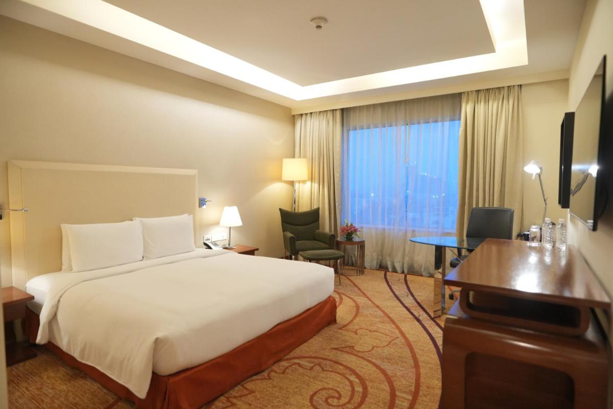 a hotel room with a bed and a desk at DoubleTree by Hilton Gurgaon New Delhi NCR in Gurgaon