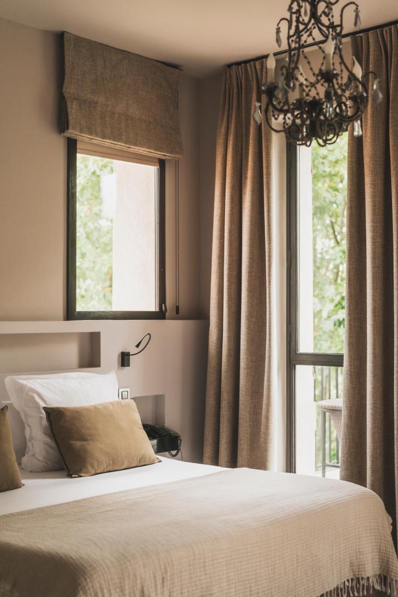 Un ou plusieurs lits dans un hébergement de l'établissement Les Lodges Sainte-Victoire Hotel & Spa