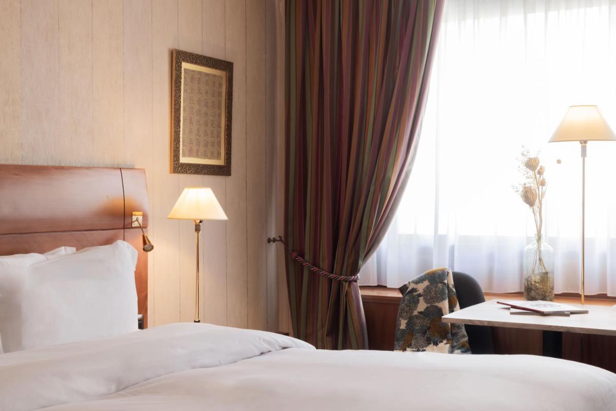 Un ou plusieurs lits dans un hébergement de l'établissement Sofitel Lyon Bellecour