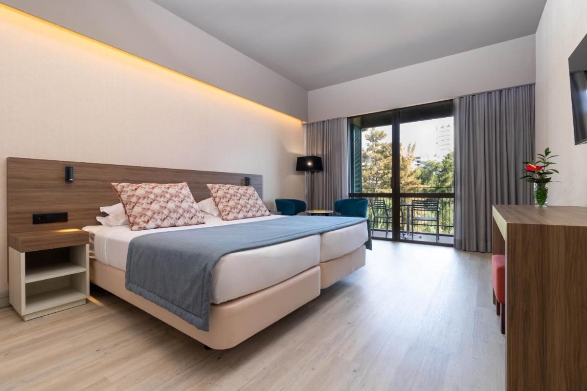 Uma cama ou camas num quarto em Enotel Magnólia
