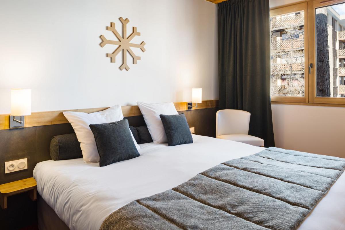Un ou plusieurs lits dans un hébergement de l'établissement Marmotel & Spa