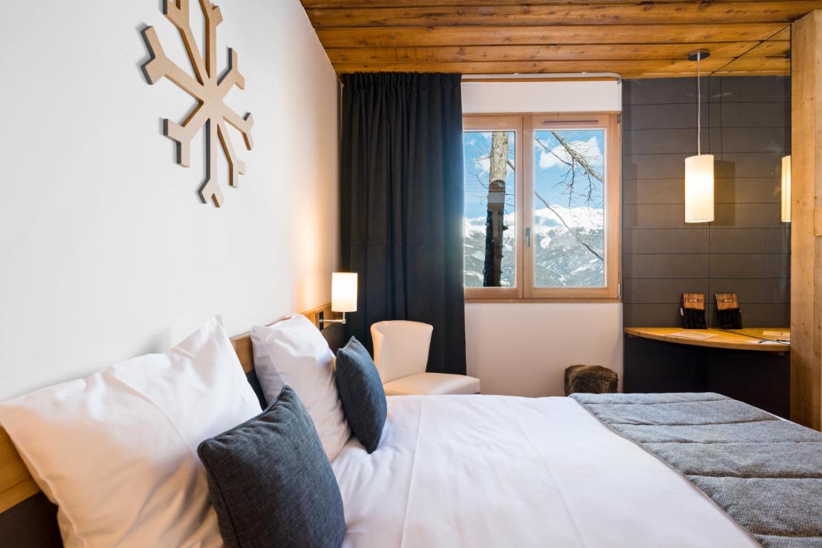 Un ou plusieurs lits dans un hébergement de l'établissement Marmotel & Spa