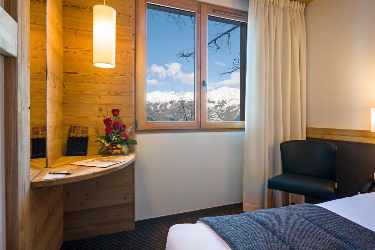 Un ou plusieurs lits dans un hébergement de l'établissement Marmotel & Spa