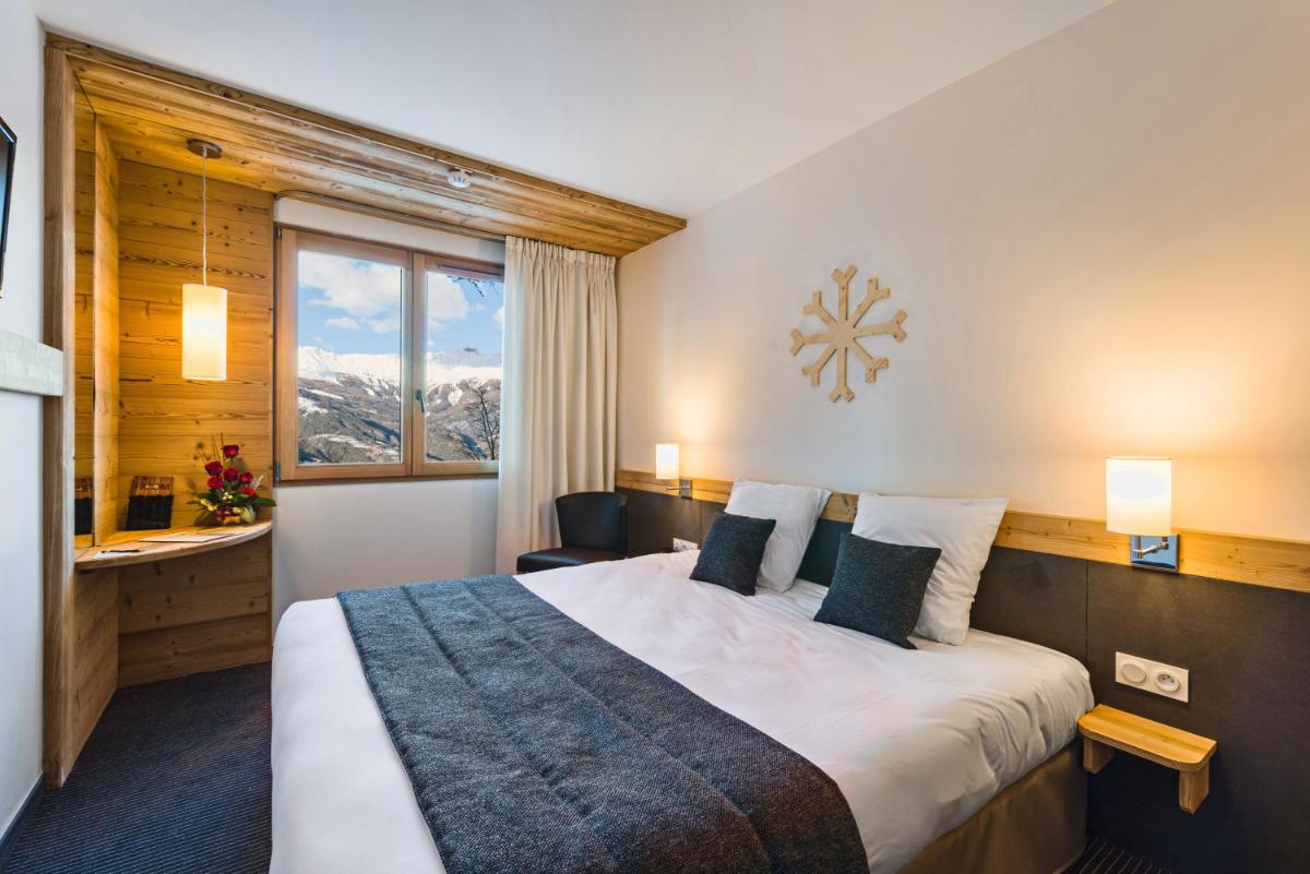 Un ou plusieurs lits dans un hébergement de l'établissement Marmotel & Spa