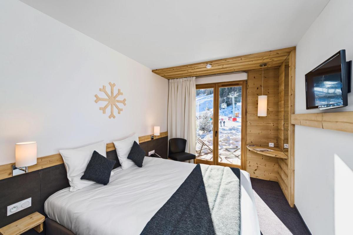 Un ou plusieurs lits dans un hébergement de l'établissement Marmotel & Spa