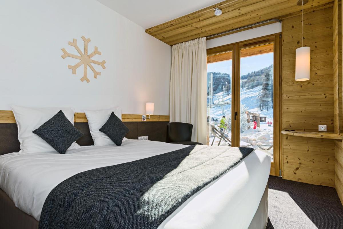 Un ou plusieurs lits dans un hébergement de l'établissement Marmotel & Spa