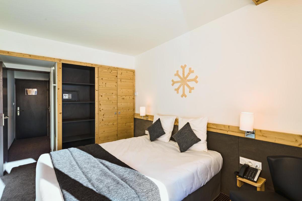 Un ou plusieurs lits dans un hébergement de l'établissement Marmotel & Spa