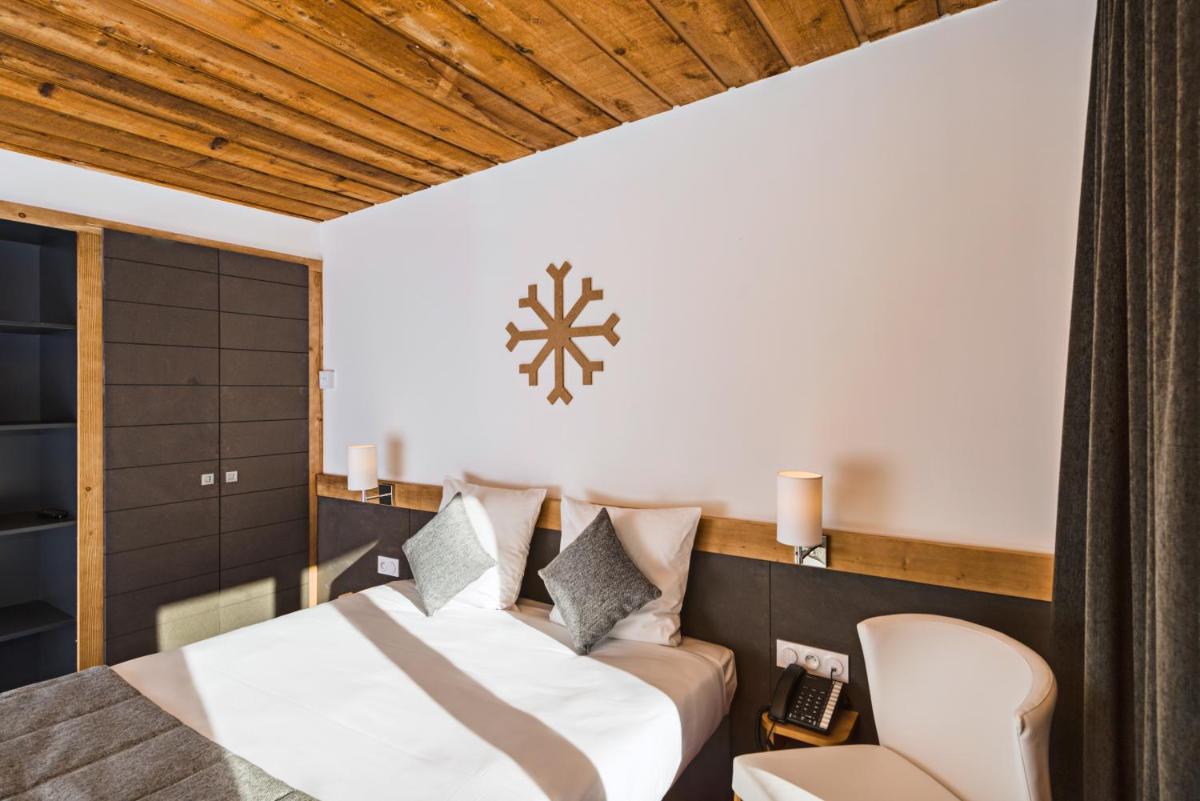 Un ou plusieurs lits dans un hébergement de l'établissement Marmotel & Spa