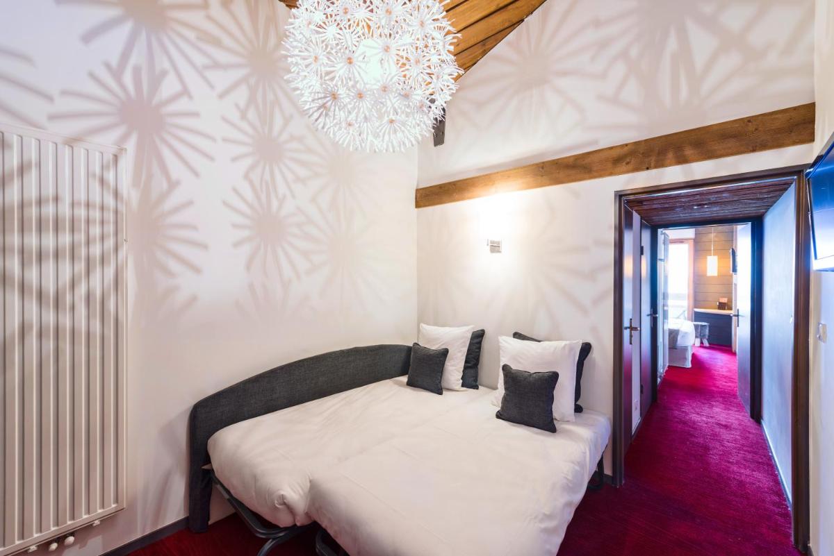 Un ou plusieurs lits dans un hébergement de l'établissement Marmotel & Spa