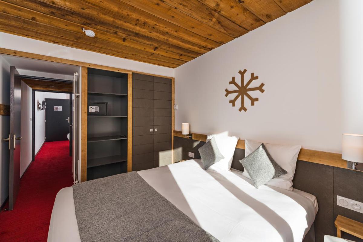 Un ou plusieurs lits dans un hébergement de l'établissement Marmotel & Spa