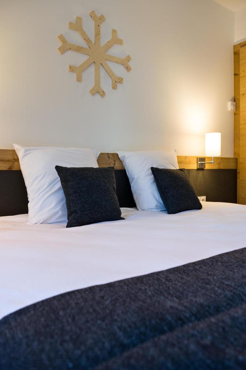 Un ou plusieurs lits dans un hébergement de l'établissement Marmotel & Spa