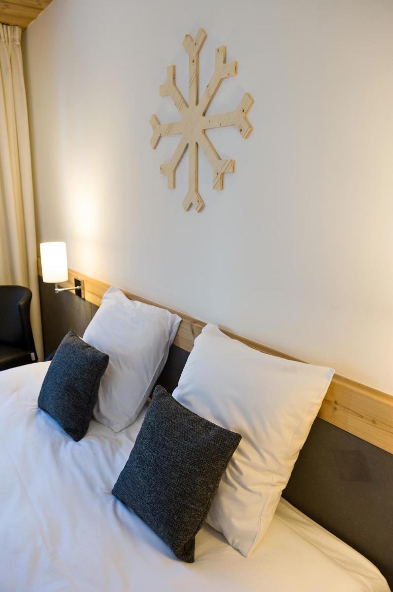 Un ou plusieurs lits dans un hébergement de l'établissement Marmotel & Spa