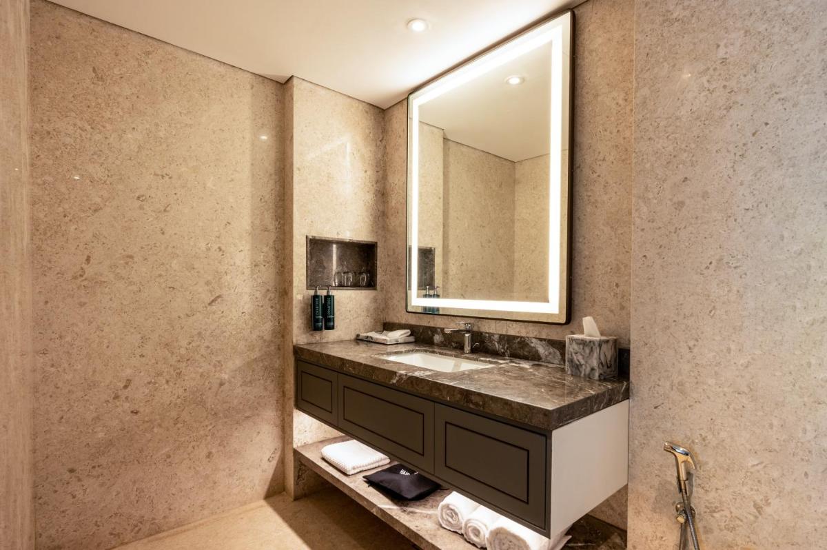 a bathroom with a sink and a mirror at Doubletree By Hilton Bengaluru Whitefield in Bengaluru