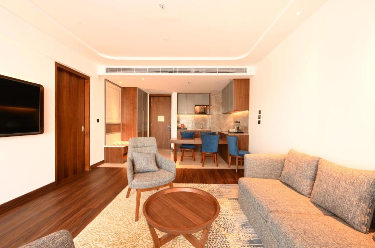 a living room with a couch and a table at Doubletree By Hilton Bengaluru Whitefield in Bengaluru