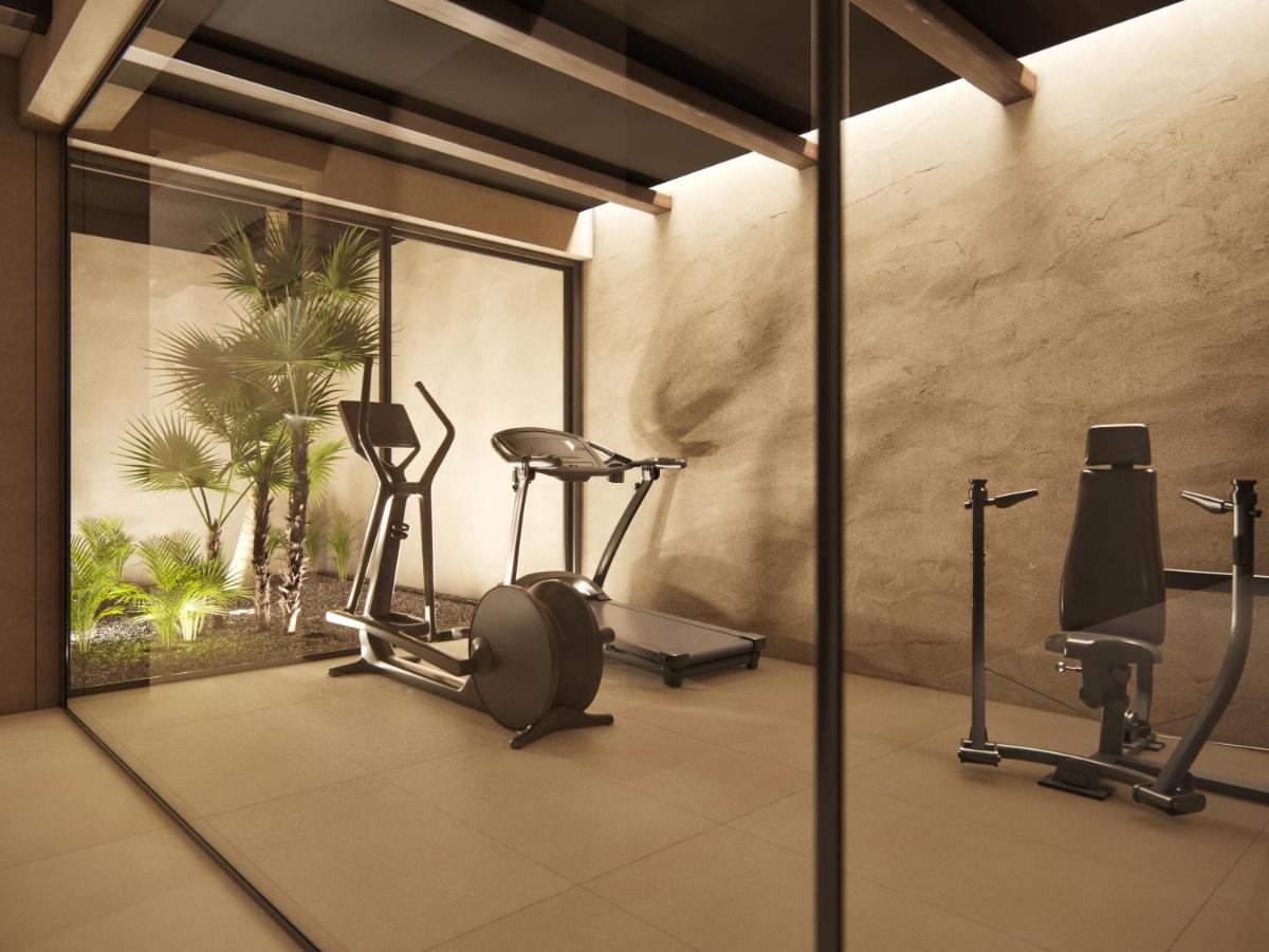 un gimnasio con cintas de correr y máquinas elípticas en Albades Hotel & Spa - Adults Only - 4 Star Superior, en Benicàssim