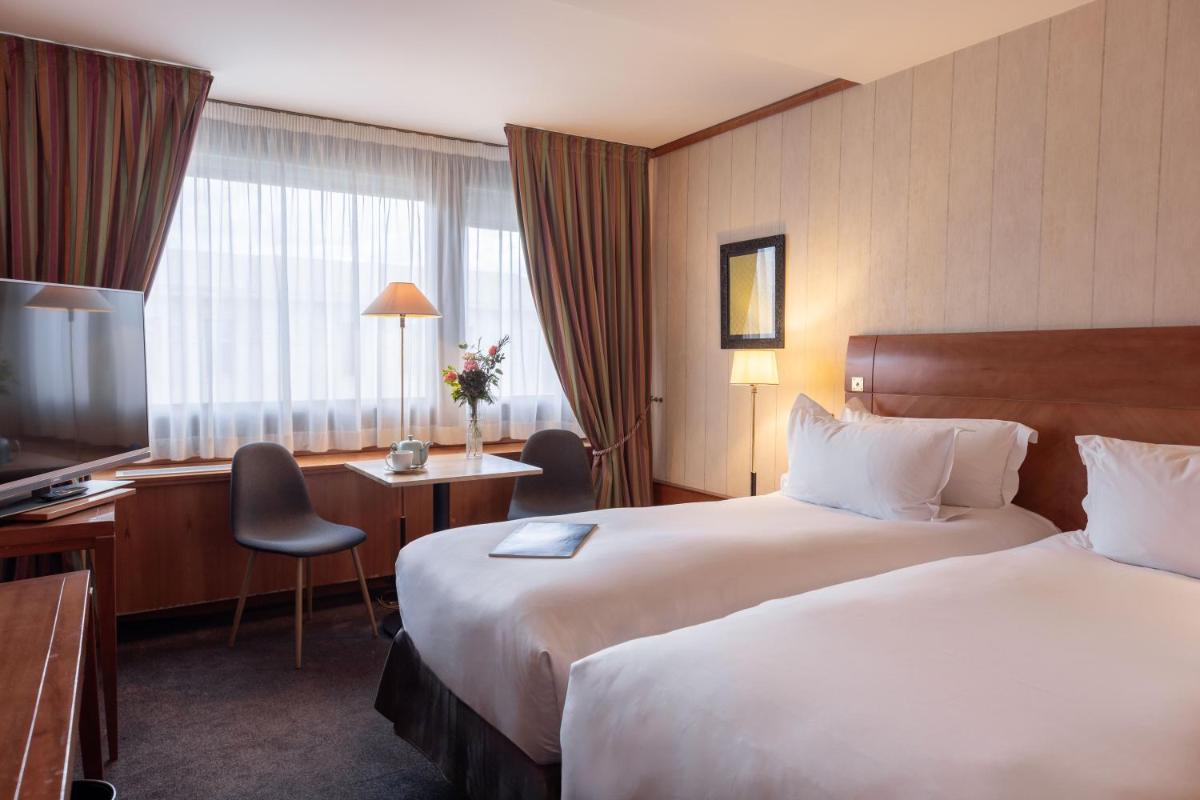 Un ou plusieurs lits dans un hébergement de l'établissement Sofitel Lyon Bellecour