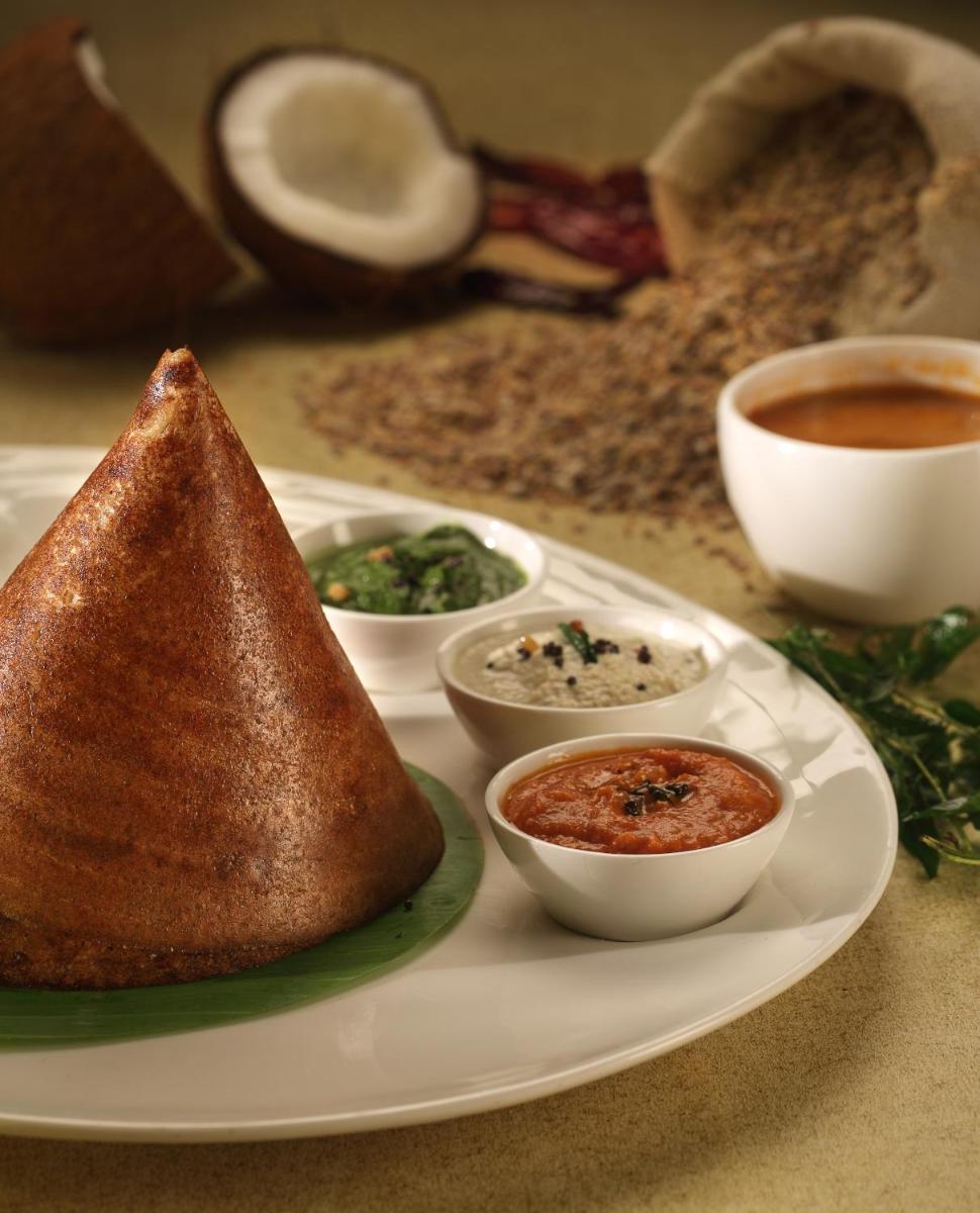 a plate of food with a pita bread and sauces at ITC Gardenia, a Luxury Collection Hotel, Bengaluru in Bengaluru a plate of food with a pita bread and sauces at ITC Gardenia, a Luxury Collection Hotel, Bengaluru in Bengaluru