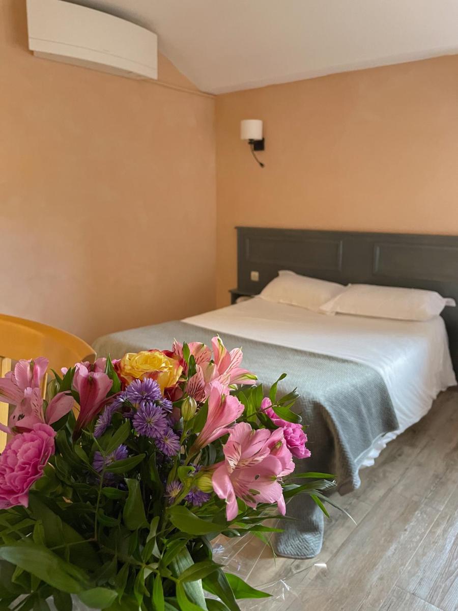 Un ou plusieurs lits dans un hébergement de l'établissement Maison Legate "Hôtel Le Baudiere & Spa"
