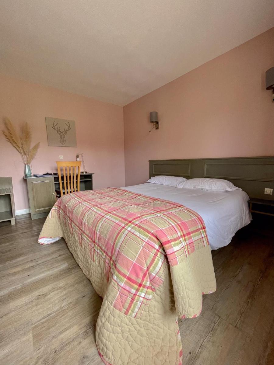 Un ou plusieurs lits dans un hébergement de l'établissement Maison Legate "Hôtel Le Baudiere & Spa"