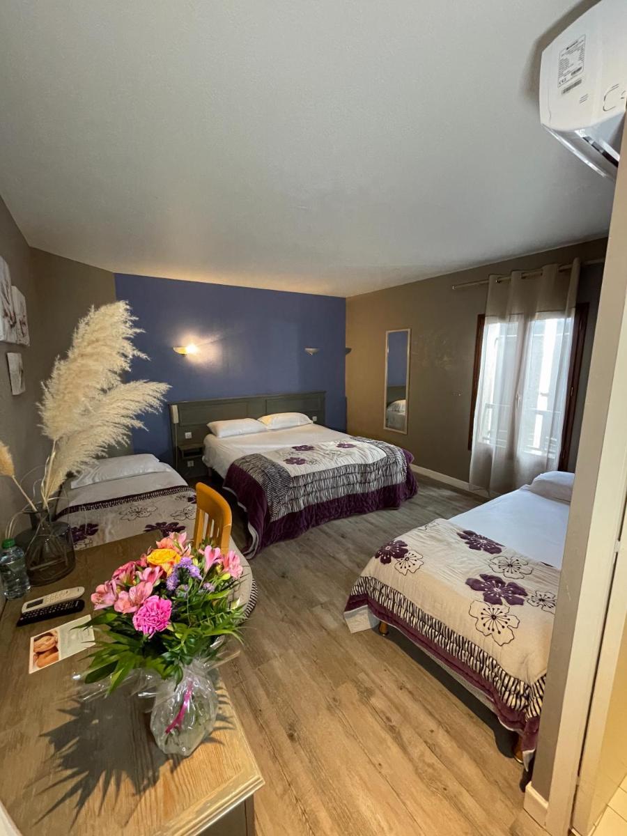 Un ou plusieurs lits dans un hébergement de l'établissement Maison Legate "Hôtel Le Baudiere & Spa"