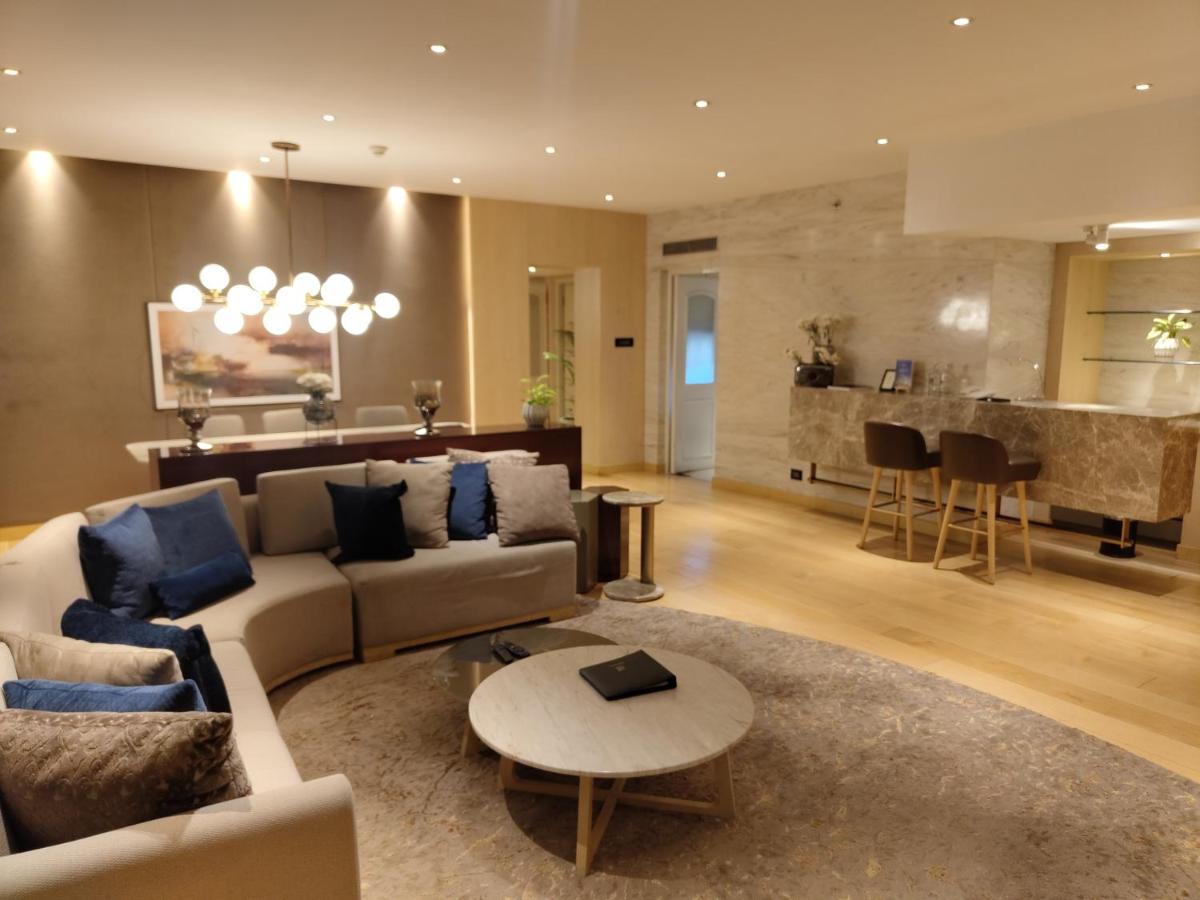 a living room with a couch and a table at Taj Lands End in Mumbai a living room with a couch and a table at Taj Lands End in Mumbai